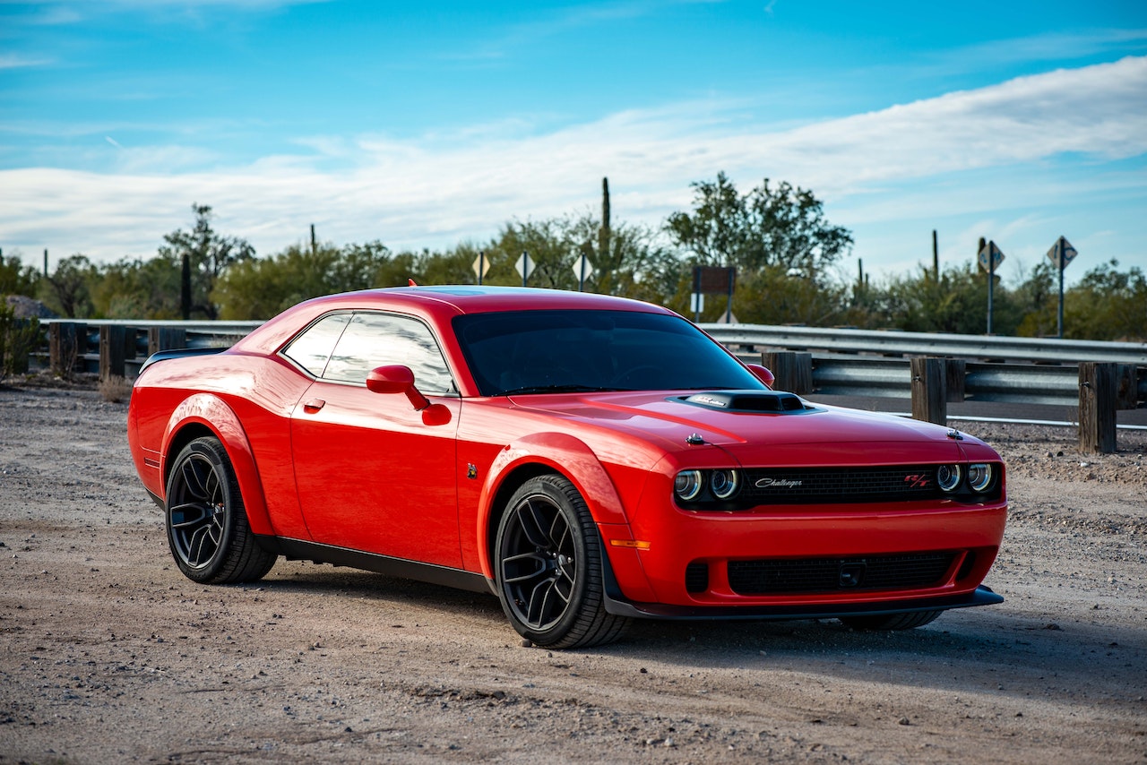 Red Chevrolet Camaro on Road | Veteran Car Donations